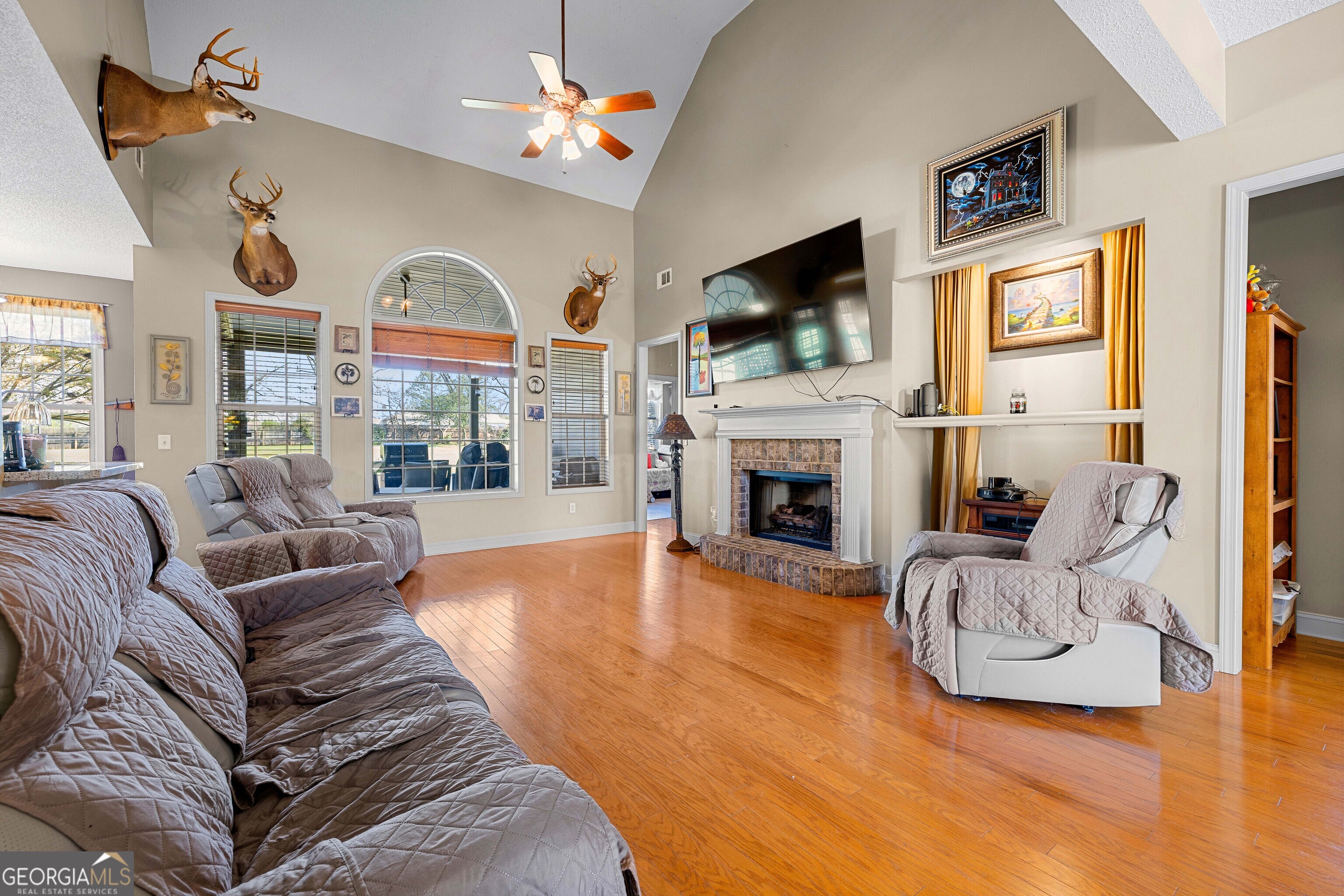 21 Hunters Overlook Drive Senoia, GA 30276 - Photo 8 of 37 a living room with furniture a fireplace and a flat screen tv