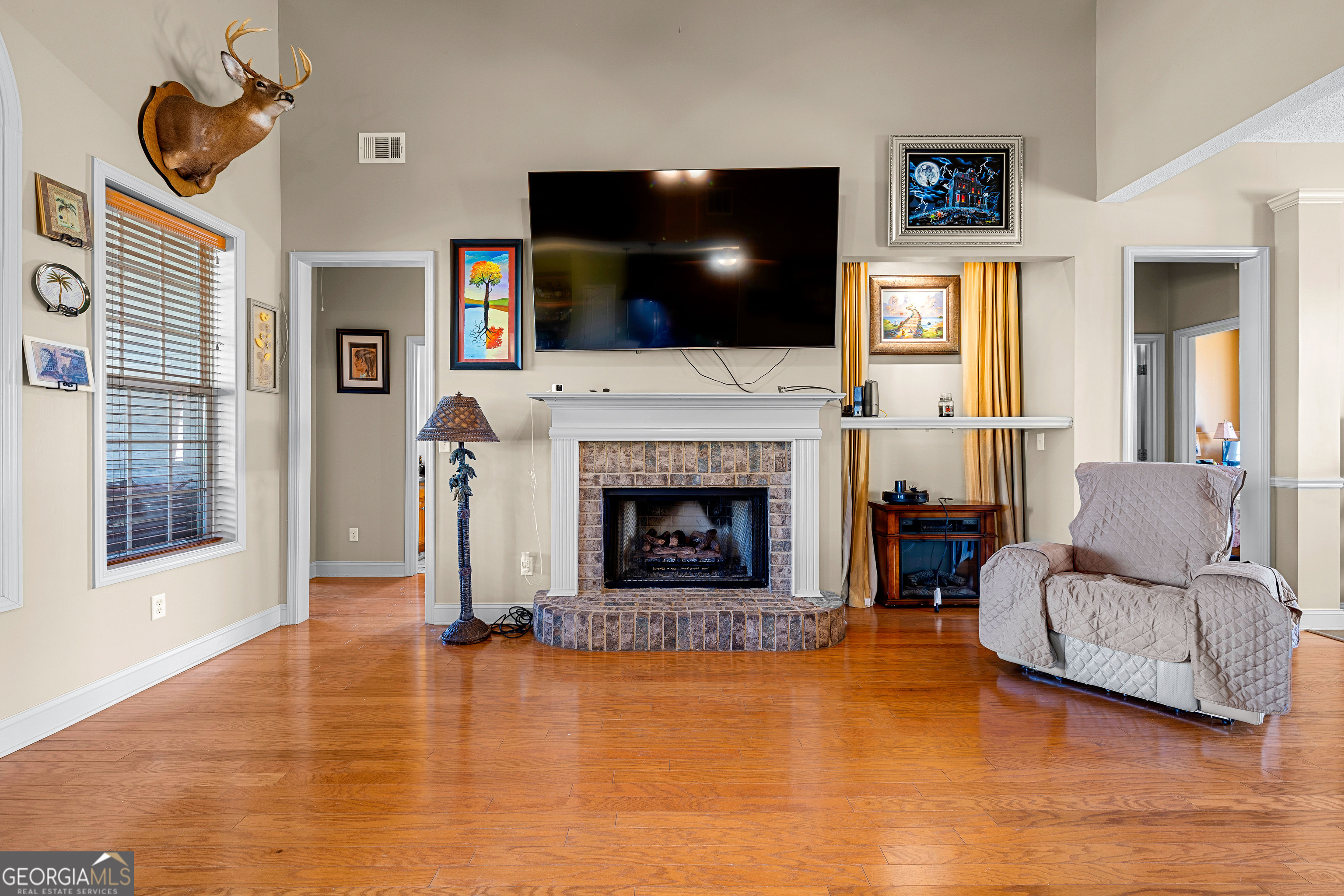 21 Hunters Overlook Drive Senoia, GA 30276 - Photo 9 of 37 a living room with furniture a flat screen tv and a fireplace
