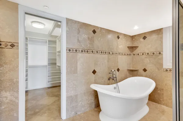 a view of walk in closet with empty racks