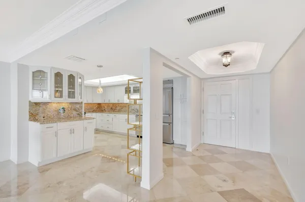 a kitchen with cabinets and wooden floor