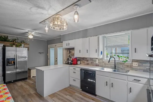 a kitchen with a sink cabinets and window