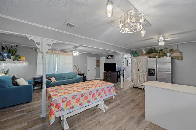 a bedroom with a bed couch and a chandelier