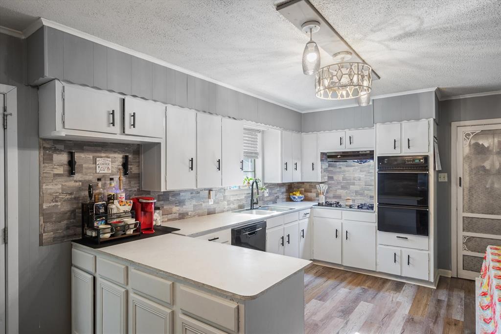 503 South Houston Street Edgewood, TX 75117 - Photo 14 of 31 a kitchen with a sink cabinets and window