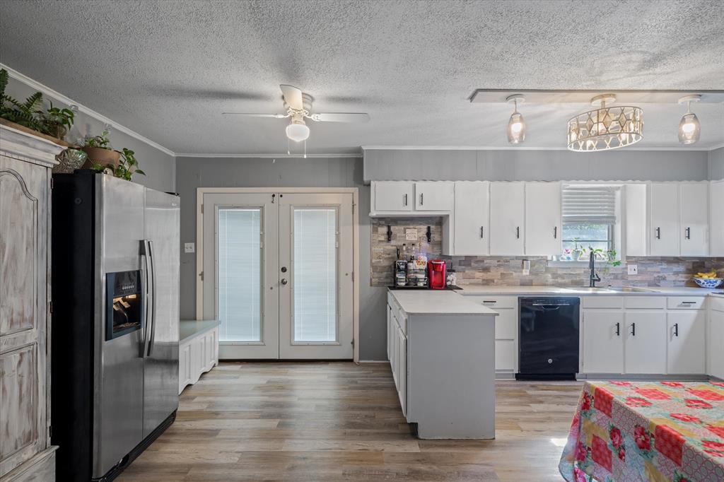 503 South Houston Street Edgewood, TX 75117 - Photo 15 of 31 a kitchen with kitchen island granite countertop a sink cabinets and stainless steel appliances