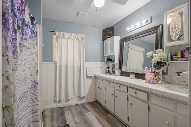 a bathroom with a double vanity sink and a mirror