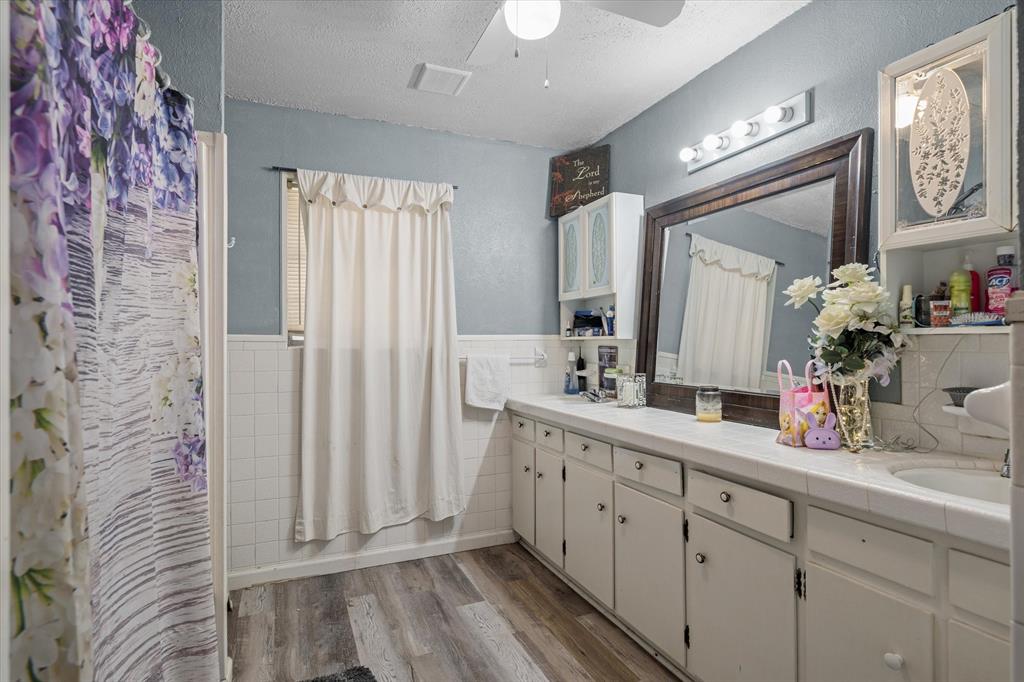503 South Houston Street Edgewood, TX 75117 - Photo 16 of 31 a bathroom with a double vanity sink and a mirror