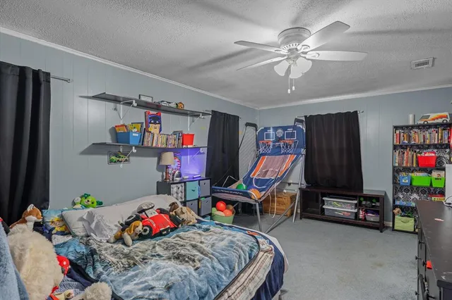 a bedroom with bed and a chandelier