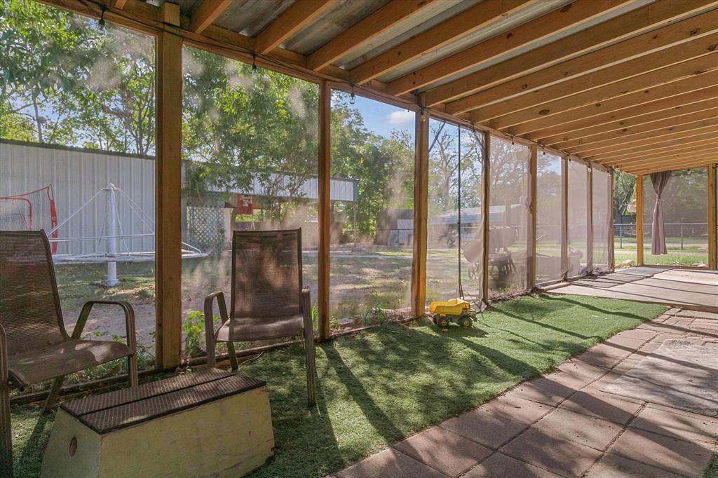 503 South Houston Street Edgewood, TX 75117 - Photo 20 of 31 a backyard of a house with a table and chairs