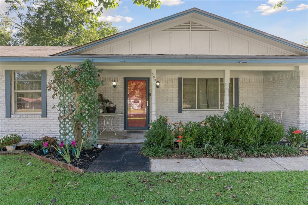 503 South Houston Street Edgewood, TX 75117 - Photo 2 of 31 a front view of a house with garden