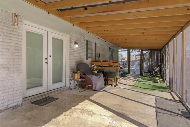 a view of a patio with table and chairs and potted plants
