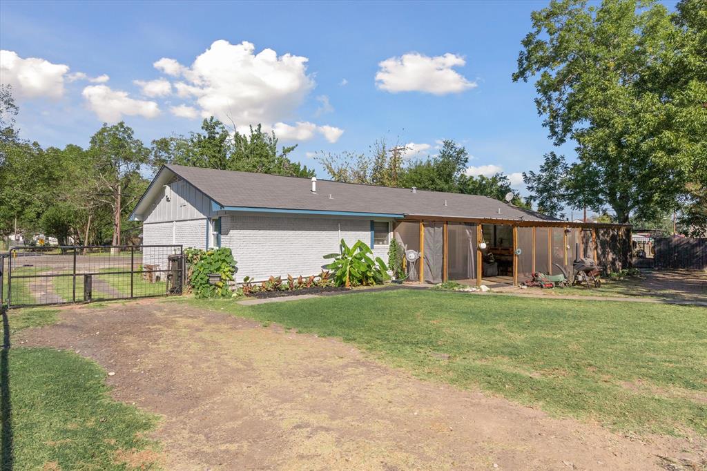503 South Houston Street Edgewood, TX 75117 - Photo 23 of 31 a house view with a garden space and wooden fence