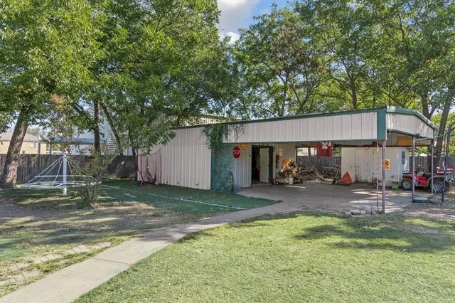 a view of a house with a yard patio and fire pit