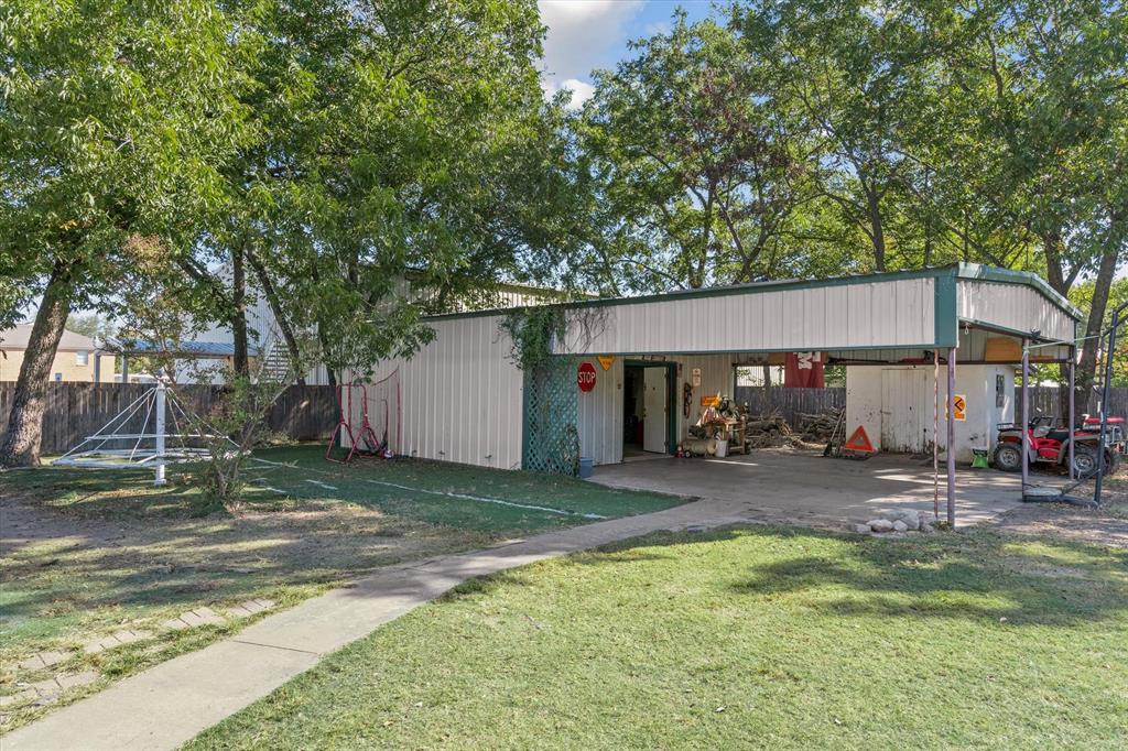 503 South Houston Street Edgewood, TX 75117 - Photo 27 of 31 a view of a house with a yard patio and fire pit