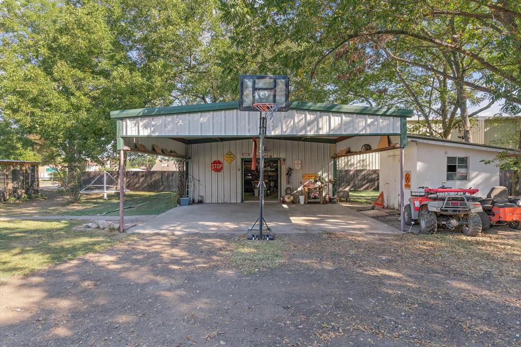 503 South Houston Street Edgewood, TX 75117 - Photo 28 of 31 a view of a house with a garage and a bike