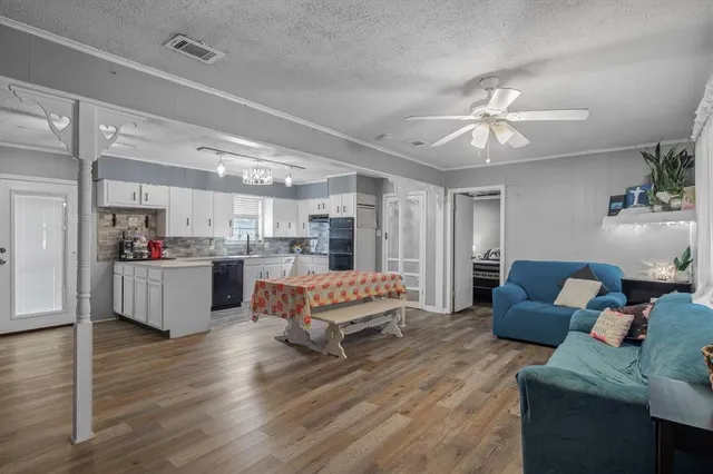 a living room with furniture and kitchen view