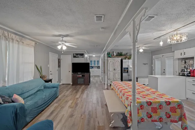 a large bedroom with a bed and a chandelier