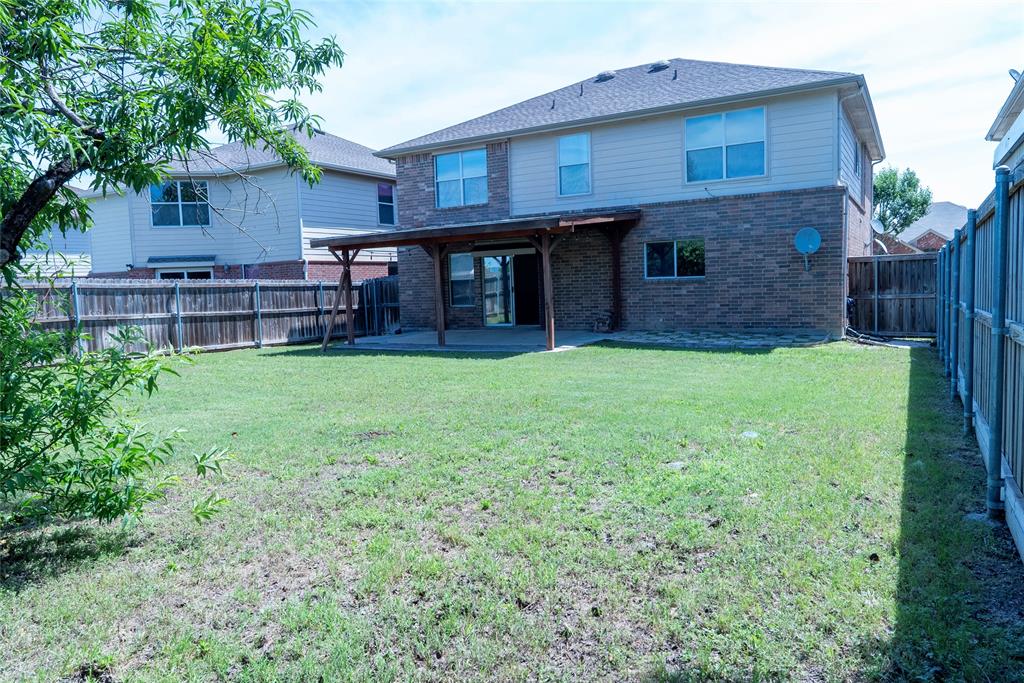8805 Graywolf Ridge Trail Fort Worth, TX 76244 - Photo 4 of 23 Brick exterior with black shutters, two-car garage, mature front yard tree, concrete driveway, and a front entry door with decorative glass