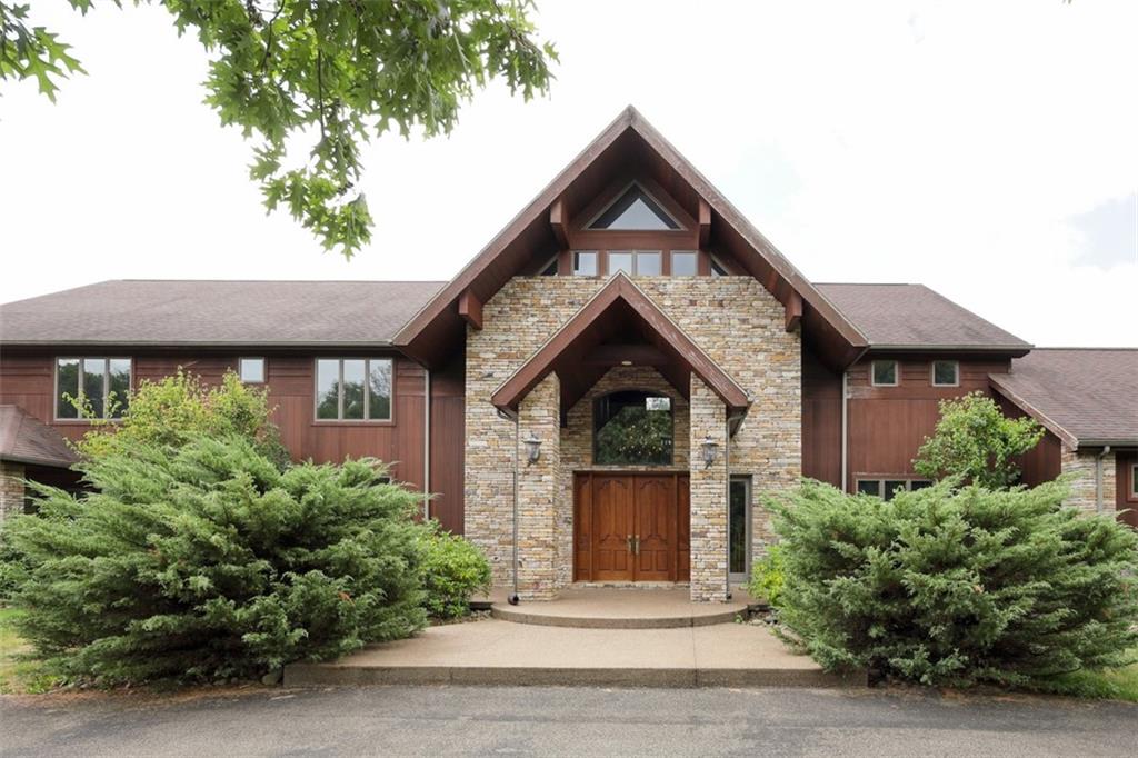 105 Serena Road Ligonier, PA 15658 - Photo 2 of 42 Stone and cedar exterior with lovely exposed aggregate walkways