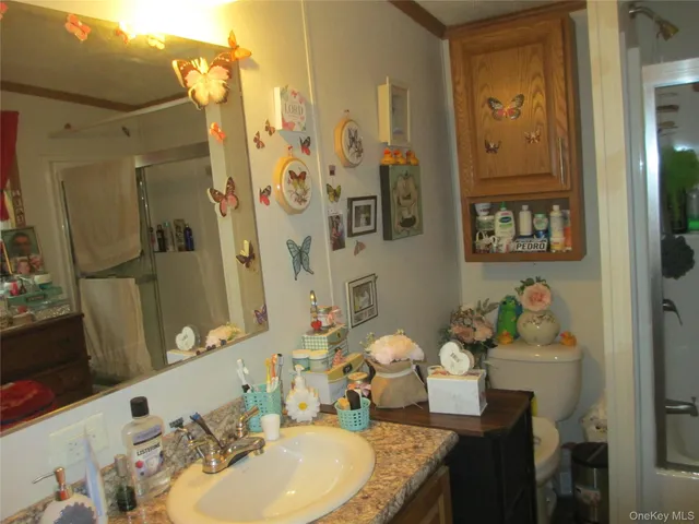 a bathroom with a granite countertop tub sink and mirror