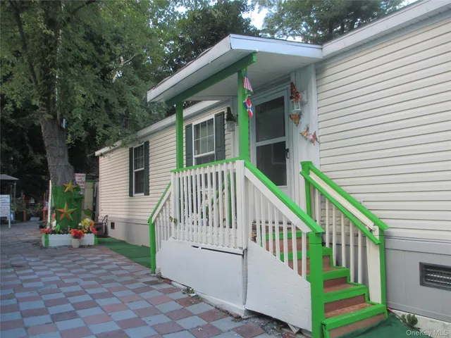 a view of house with a deck and furniture