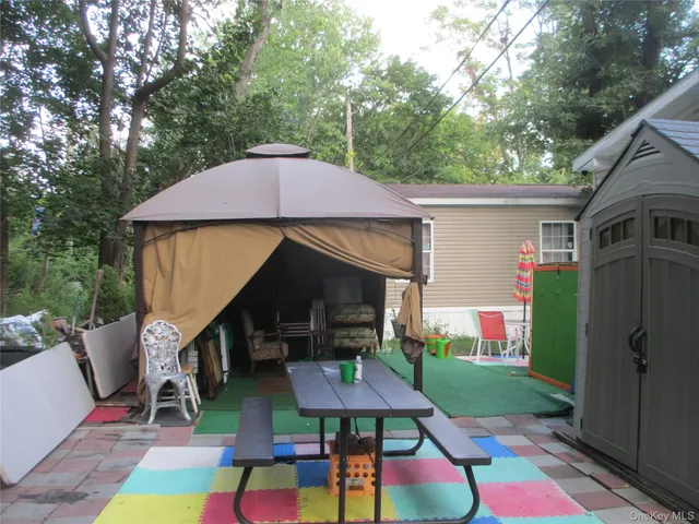 a front view of house with yard and outdoor seating