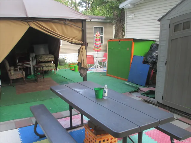 a view of house with backyard outdoor seating