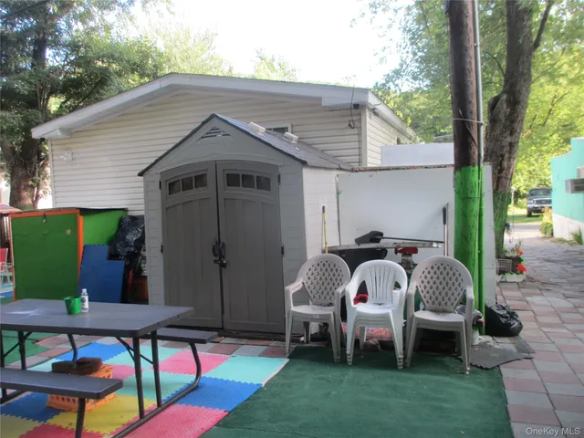 a view of backyard with outdoor seating and green space