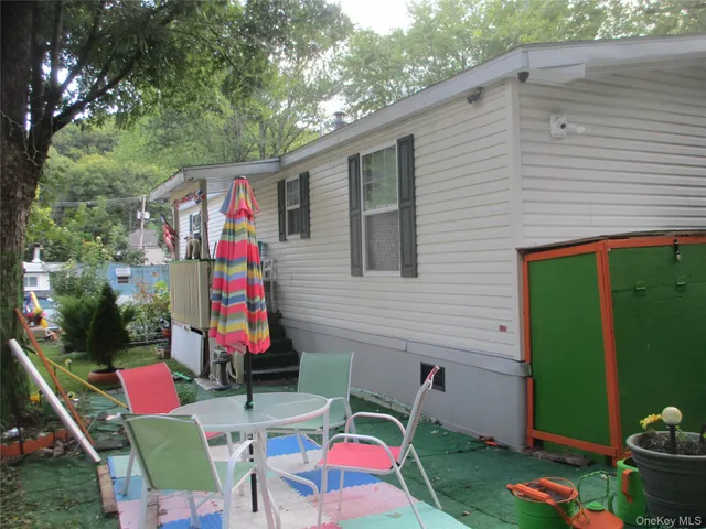 a backyard of a house with seating space and trampoline
