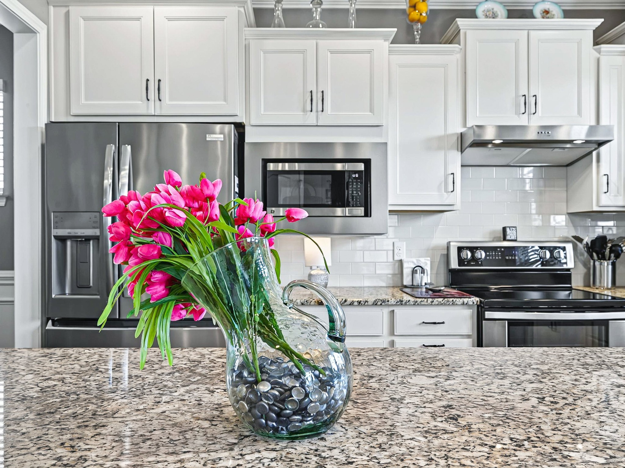 141 Tipton Pass Spring Hill, TN 37174 - Photo 11 of 49 a kitchen with stainless steel appliances kitchen island granite countertop a stove a sink dishwasher and cabinets