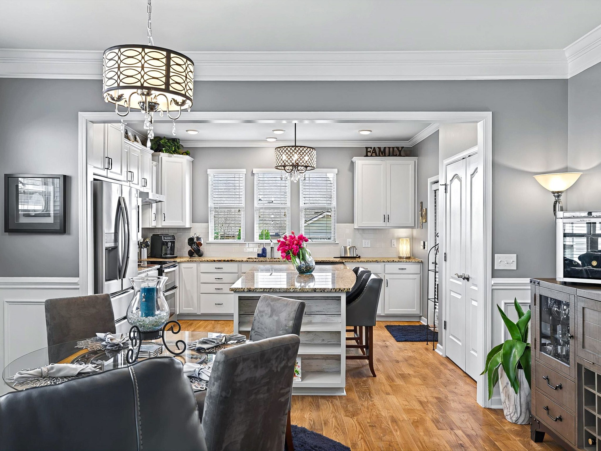 141 Tipton Pass Spring Hill, TN 37174 - Photo 9 of 49 a view of a dining room with furniture a chandelier and wooden floor
