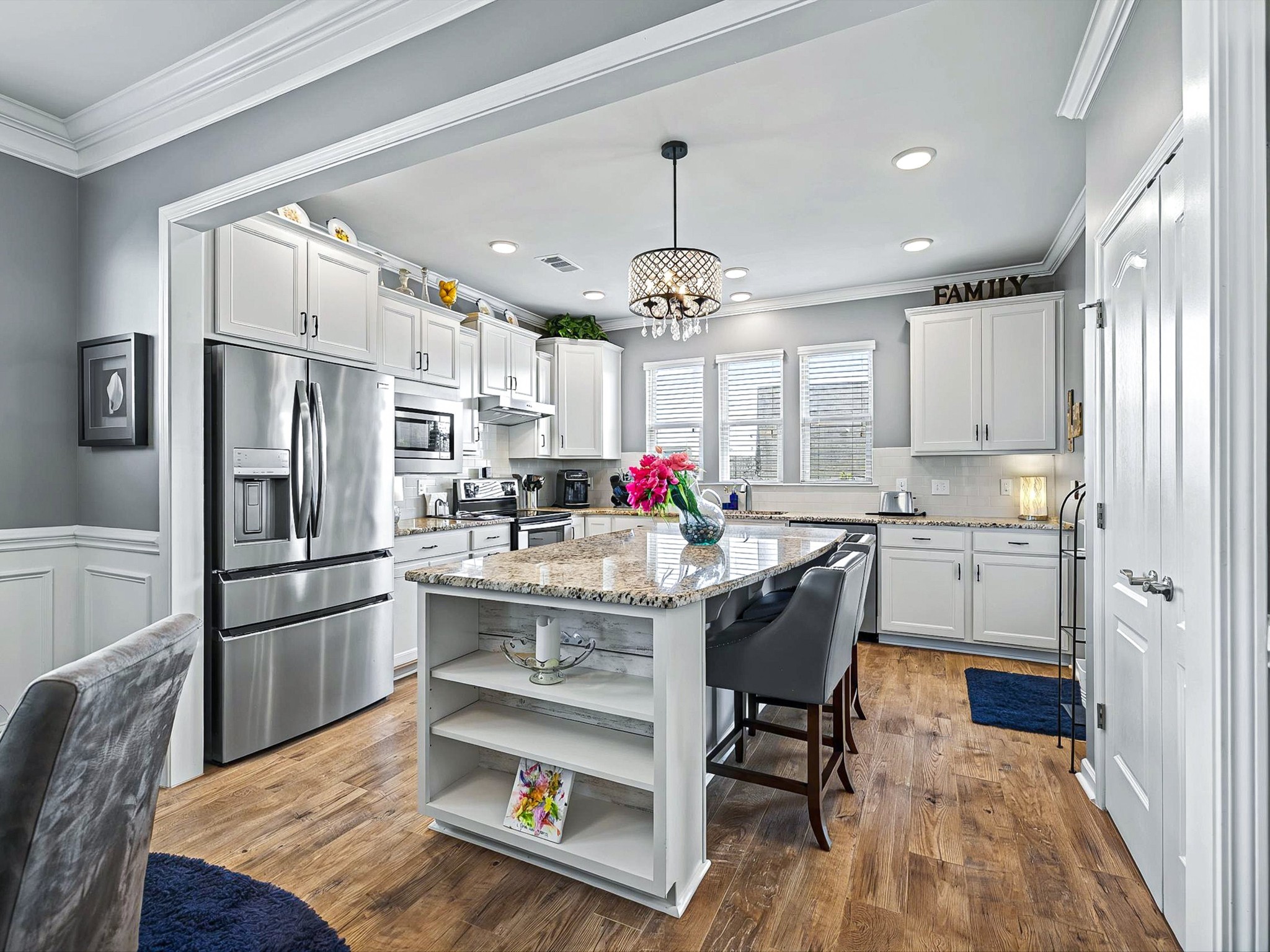 141 Tipton Pass Spring Hill, TN 37174 - Photo 10 of 49 a kitchen with granite countertop a refrigerator and white cabinets
