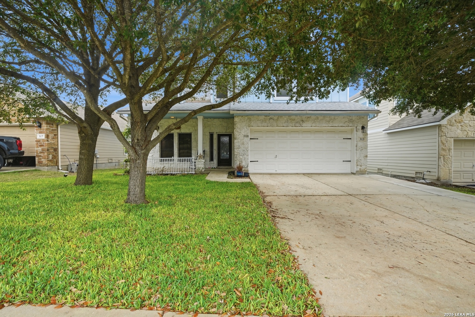 a front view of house with yard and green space