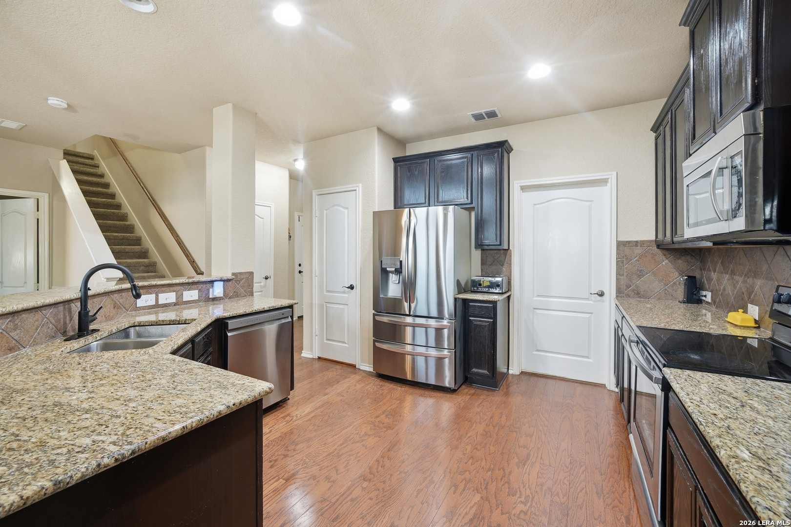 313 Brook Shadow Cibolo, TX 78108 - Photo 8 of 29 a kitchen with kitchen island a sink stove and refrigerator