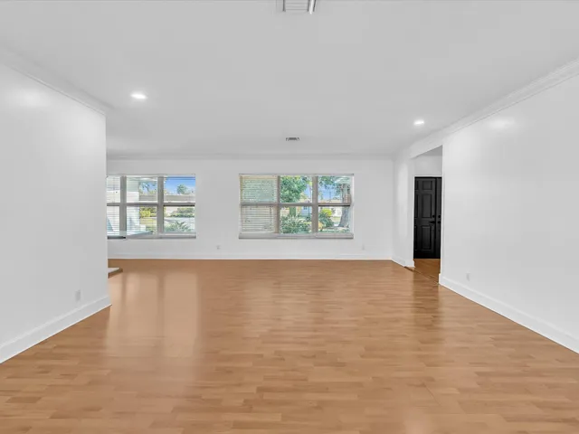 a view of an empty room with a fireplace and a large window