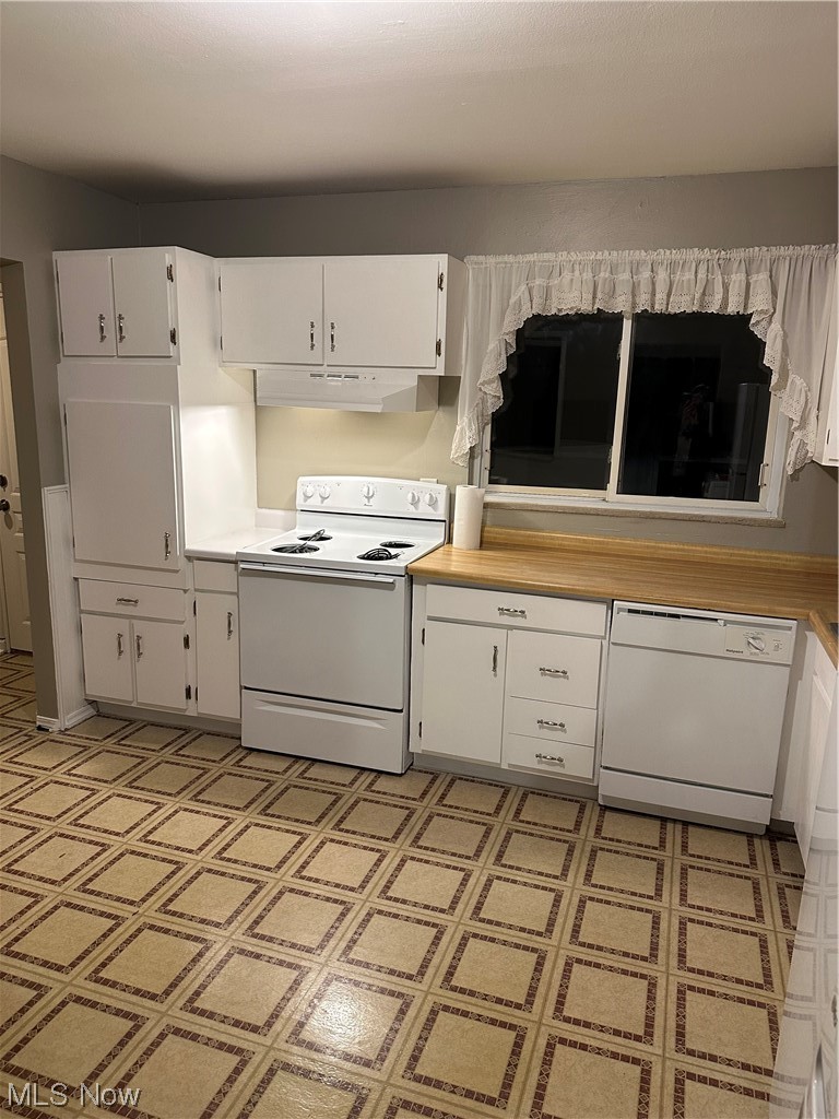 4473 Burkey Road Youngstown, OH 44515 - Photo 7 of 27 Kitchen with dishwasher, white electric range oven, light tile floors, ventilation hood, and white cabinetry