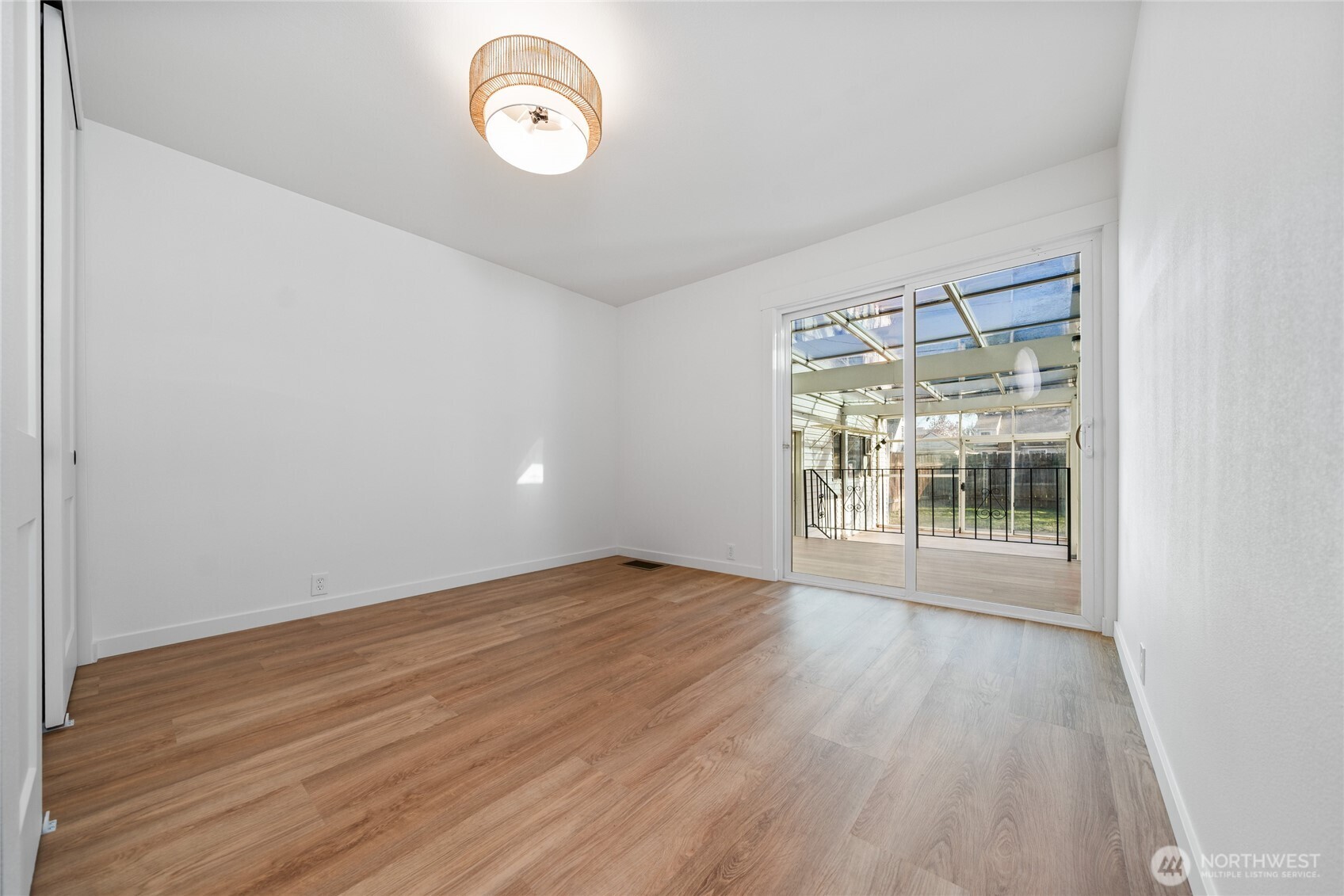 1308 19th Avenue Longview, WA 98632 - Photo 11 of 24 a view of an empty room with wooden floor and a window