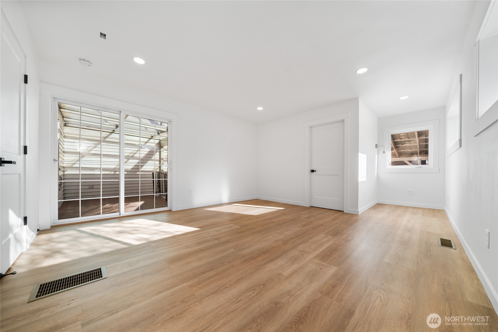 1308 19th Avenue Longview, WA 98632 - Photo 14 of 24 an empty room with wooden floor and windows