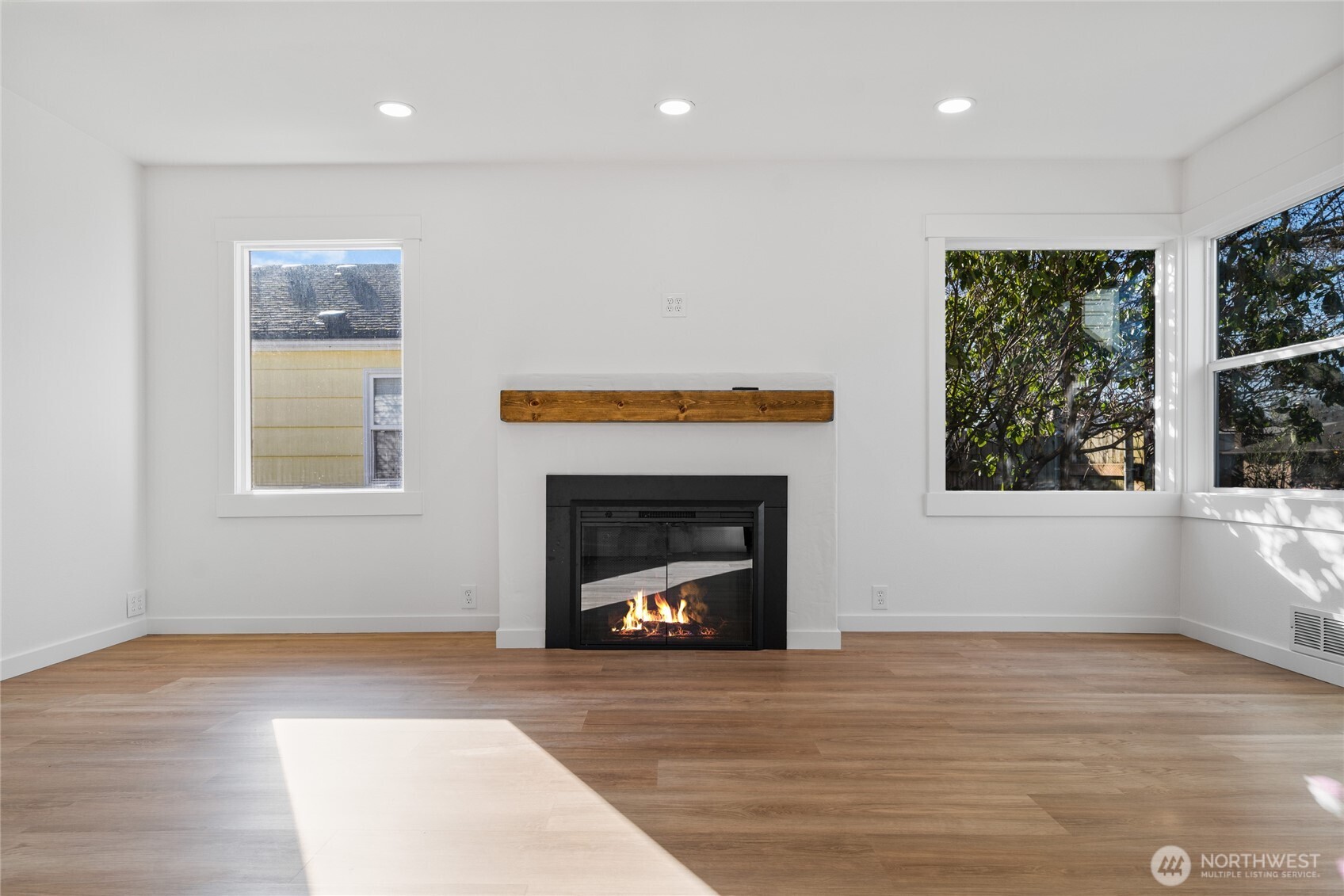 1308 19th Avenue Longview, WA 98632 - Photo 4 of 24 a living room with a fireplace and a floor to ceiling window