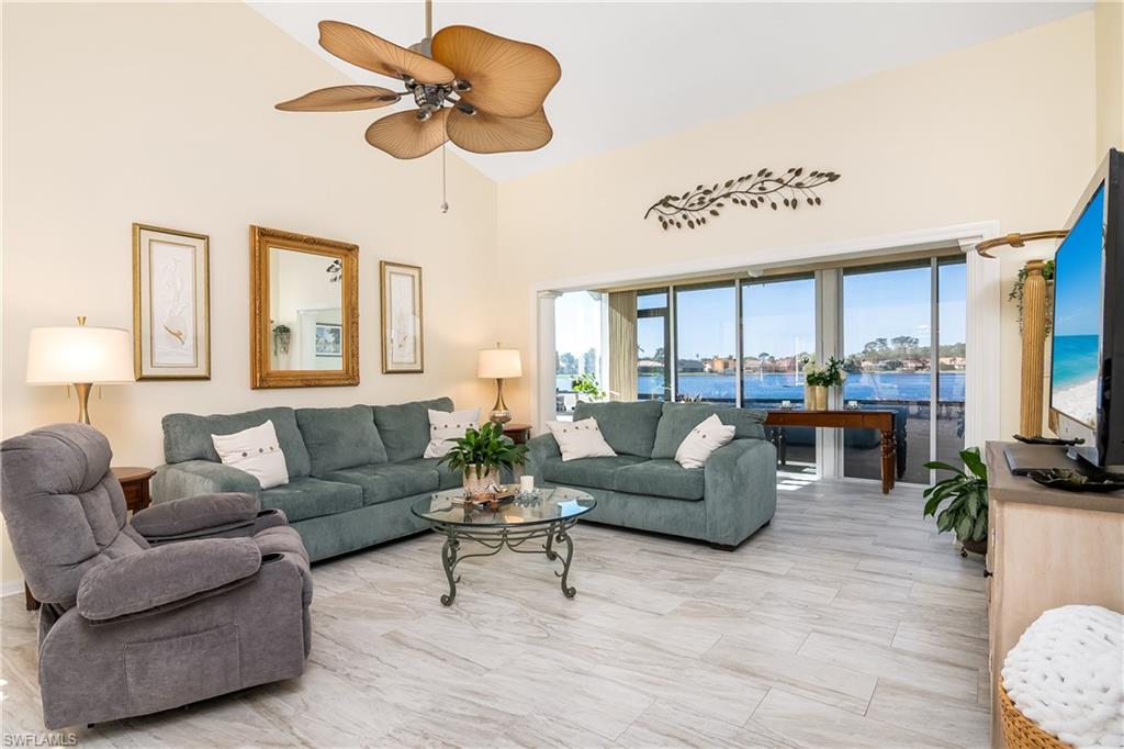a living room with furniture ceiling fan and a window