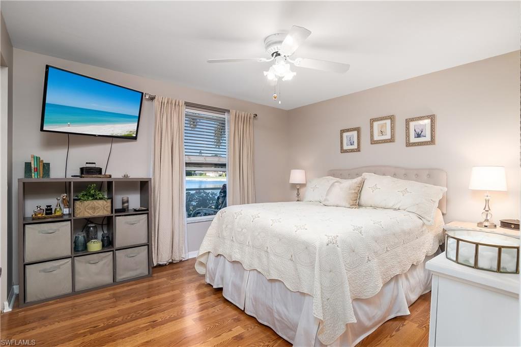 613 Windsor Square, Unit 101 Naples, FL 34104 - Photo 17 of 23 a large white bed in a white bedroom