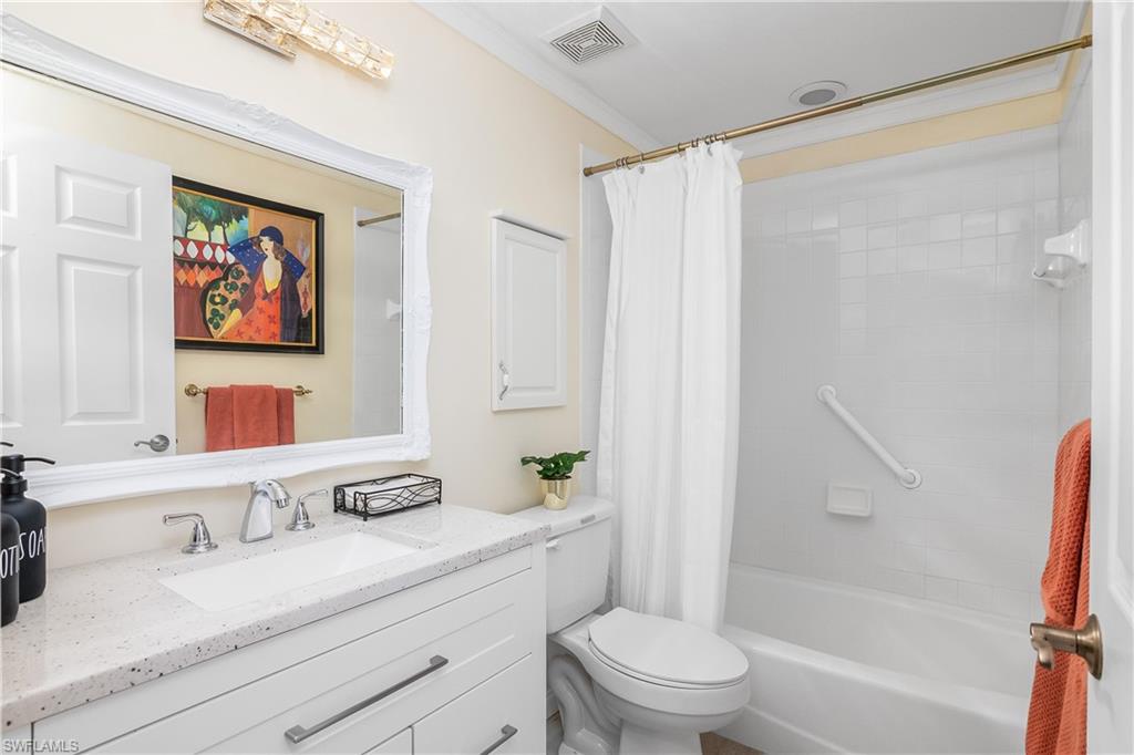 613 Windsor Square, Unit 101 Naples, FL 34104 - Photo 18 of 23 a bathroom with a granite countertop sink a toilet and shower