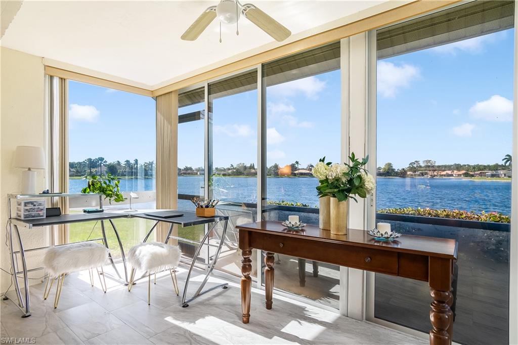 613 Windsor Square, Unit 101 Naples, FL 34104 - Photo 2 of 23 a view of a living room with furniture and floor to ceiling window