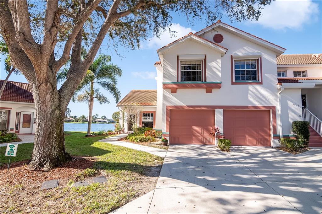 613 Windsor Square, Unit 101 Naples, FL 34104 - Photo 7 of 23 a front view of a house with garden