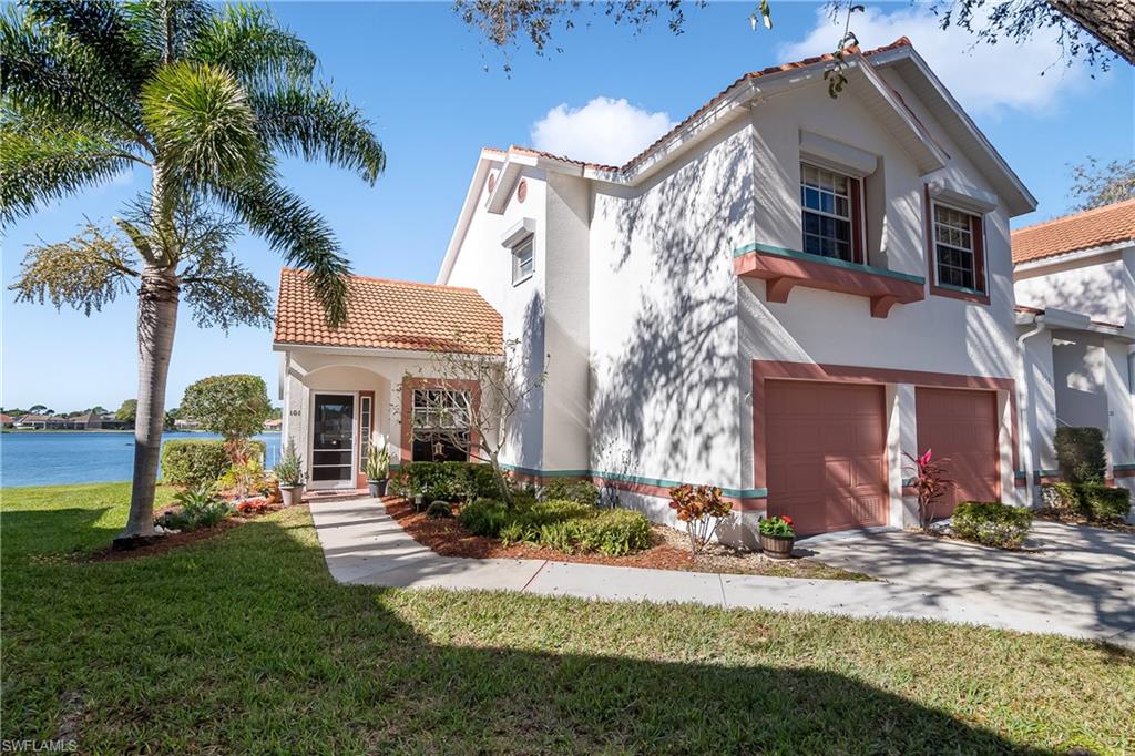 613 Windsor Square, Unit 101 Naples, FL 34104 - Photo 8 of 23 a front view of a house with garden