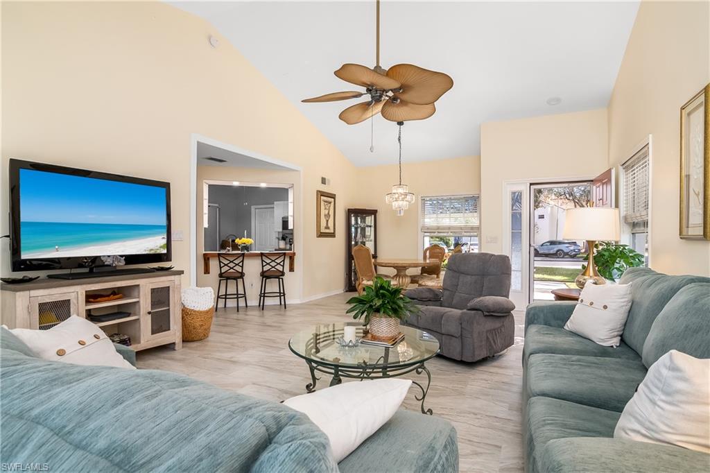 613 Windsor Square, Unit 101 Naples, FL 34104 - Photo 10 of 23 a living room with furniture and a flat screen tv
