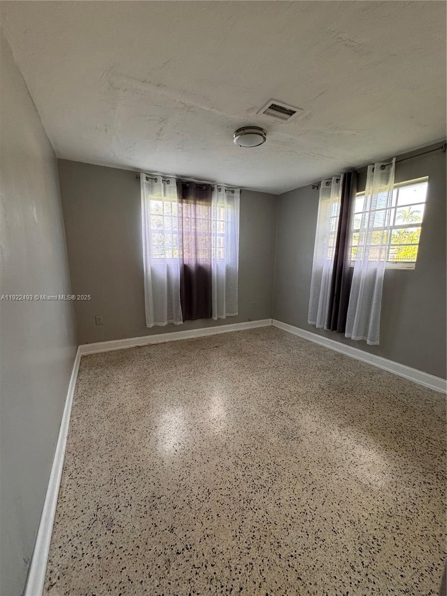 316 Southwest 2nd Terrace Hallandale Beach, FL 33009 - Photo 11 of 16 wooden floor in an empty room with a window