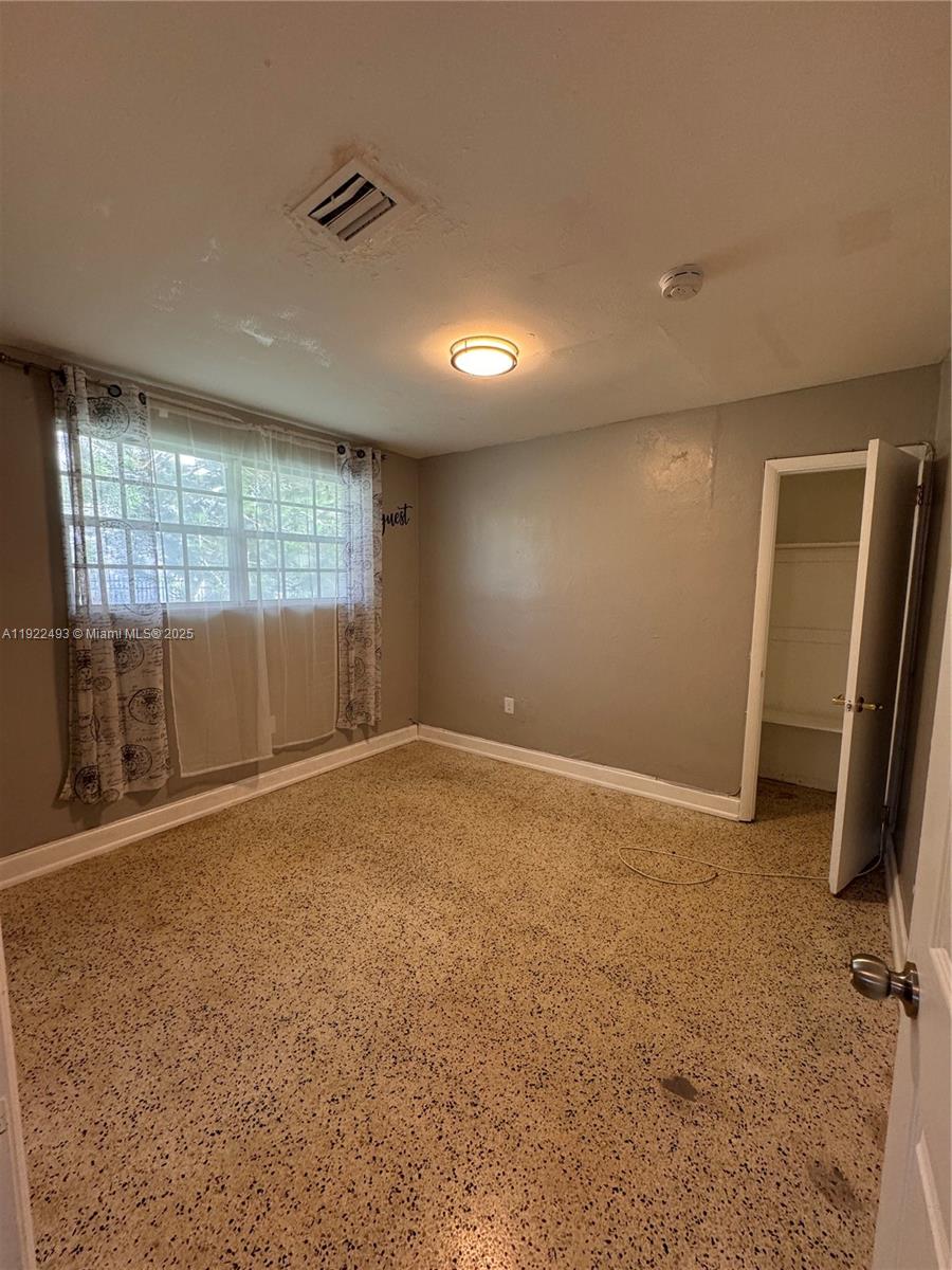 316 Southwest 2nd Terrace Hallandale Beach, FL 33009 - Photo 13 of 16 an empty room with a fireplace and windows