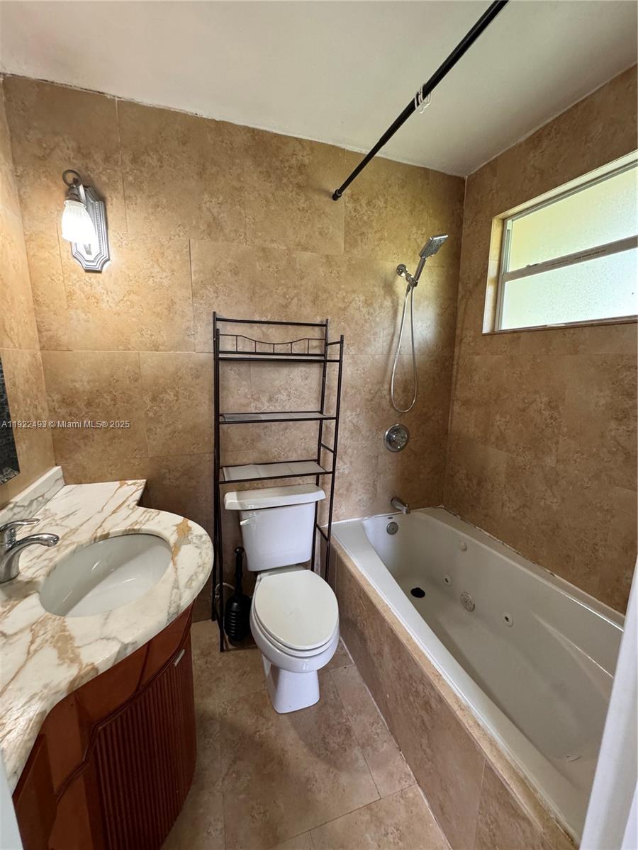 316 Southwest 2nd Terrace Hallandale Beach, FL 33009 - Photo 15 of 16 a bathroom with a sink a toilet and shower