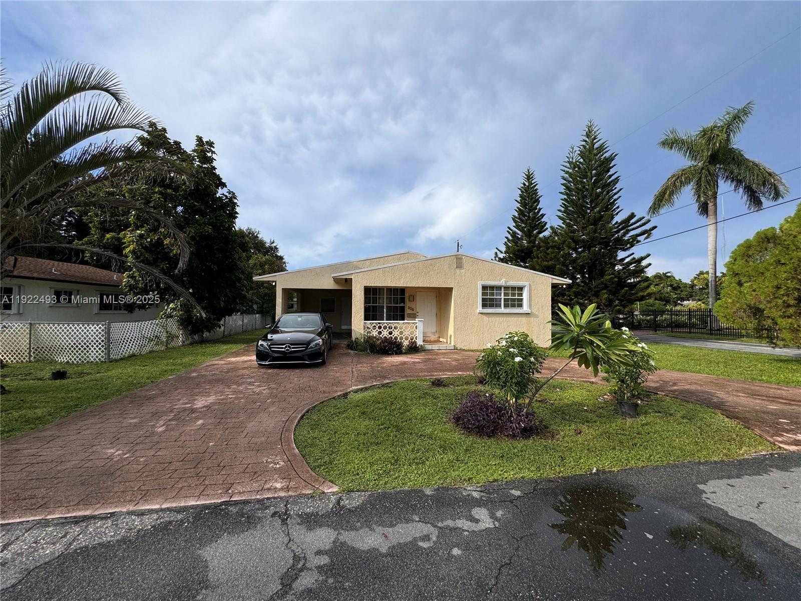 316 Southwest 2nd Terrace Hallandale Beach, FL 33009 - Photo 3 of 16 a front view of a house with garden