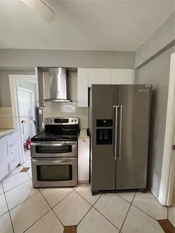a kitchen with appliances and a refrigerator